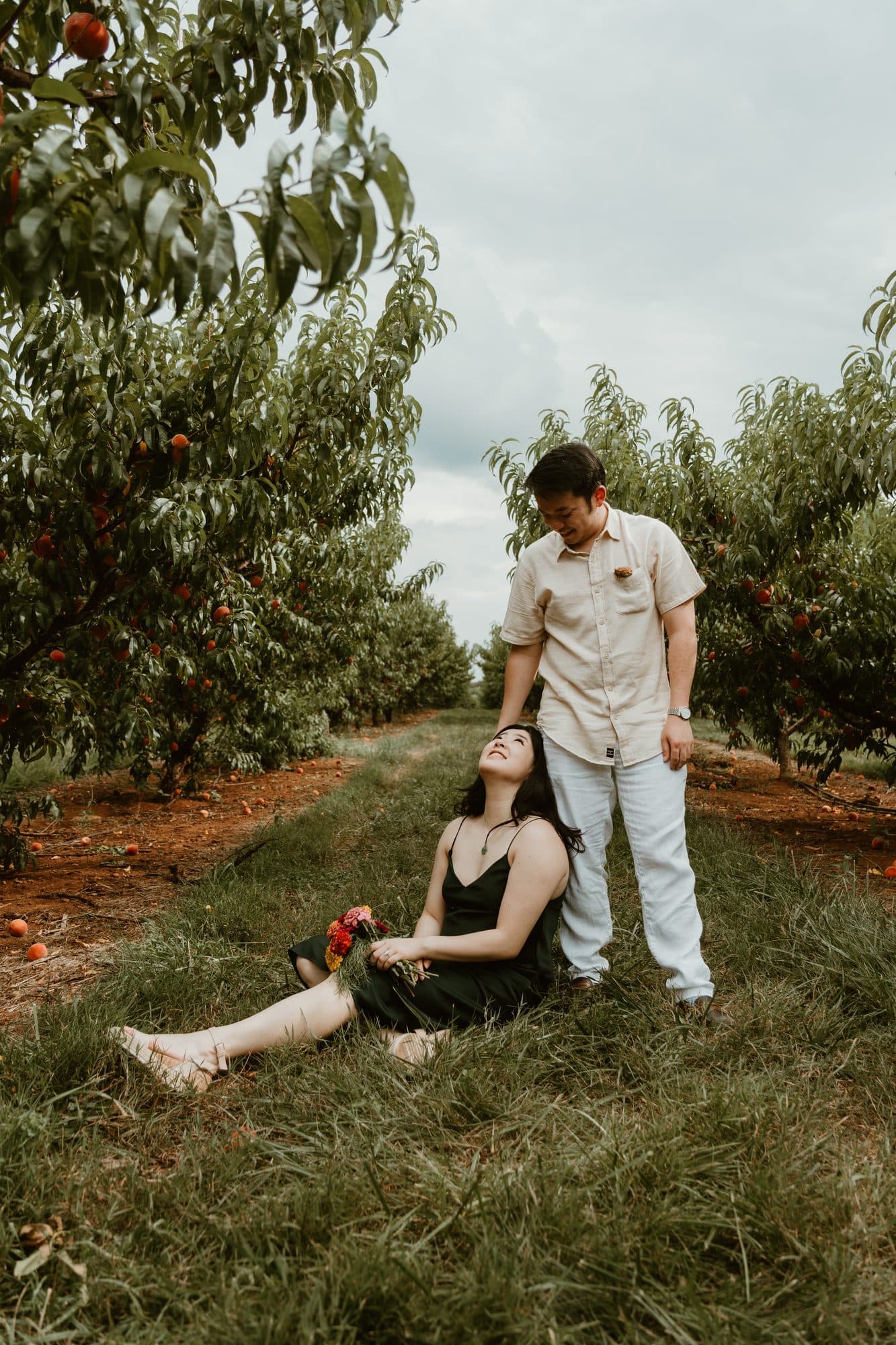 Jeffrey and Katie beneath the peach trees in late summer